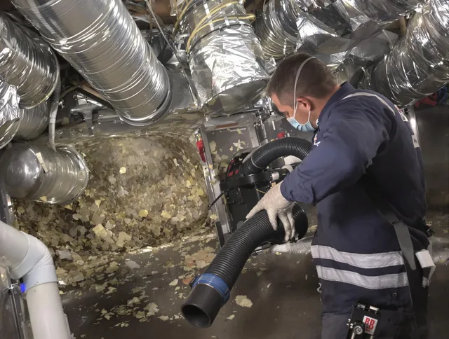 Lakeville Air Duct Cleaning specialist operating negative pressure cleaning equipment for thorough duct maintenance in Lakeville