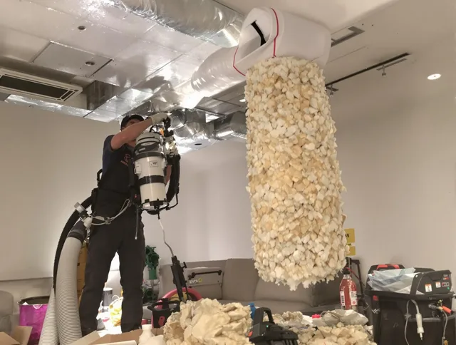 Lakeville Air Duct Cleaning technician performing precision vacuum insulation removal in a residential property in Lakeville